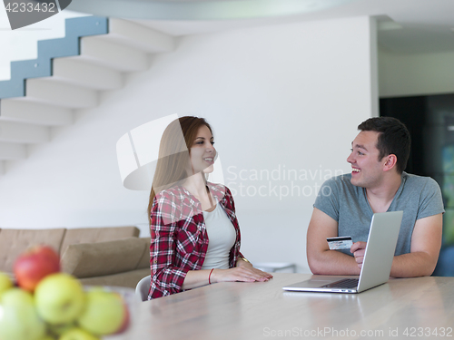 Image of happy young couple buying online