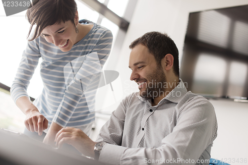 Image of Two Business People Working With Tablet in startup office