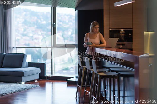 Image of woman eating breakfast enjoying relaxing lifestyle