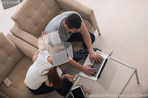 Image of happy young couple buying online