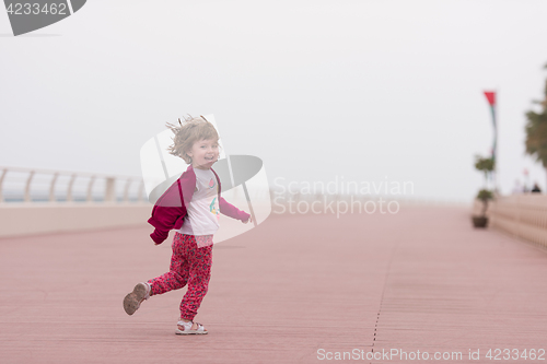 Image of cute little girl on the promenade by the sea