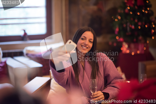 Image of woman drinking doing selfy at spa