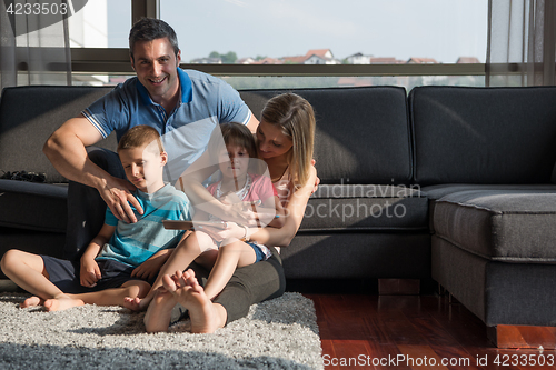 Image of happy young couple spending time with kids