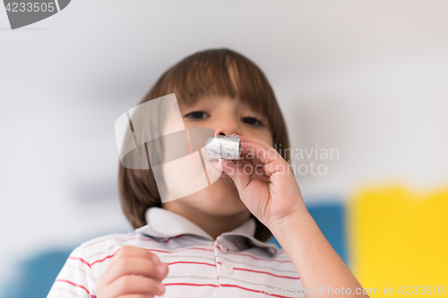 Image of kid blowing a noisemaker