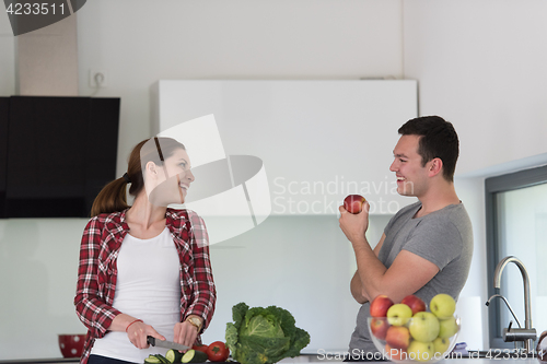 Image of Young handsome couple in the kitchen