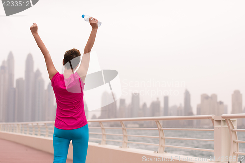 Image of young woman celebrating a successful training run