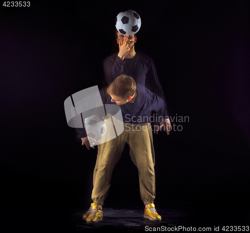 Image of A portrait of a fan with ball on gray studio background. Freestile