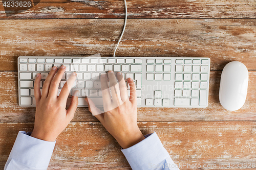 Image of close up of hands typing on keyboard