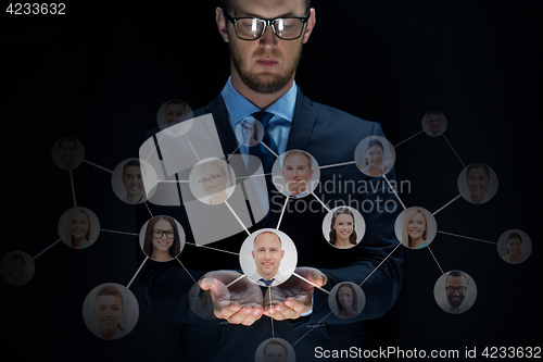 Image of businessman with network contacts over black