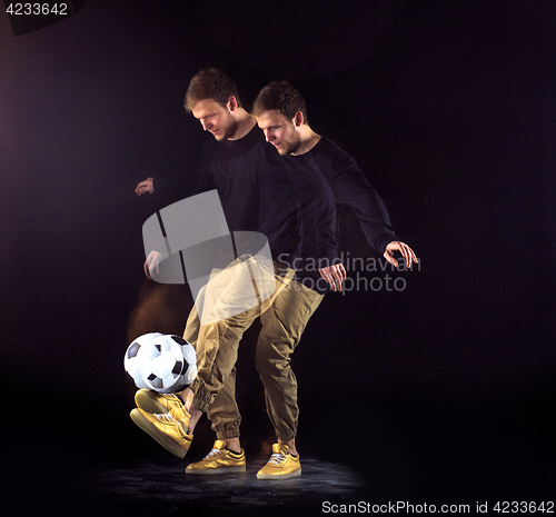 Image of A portrait of a fan with ball on gray studio background. Freestile