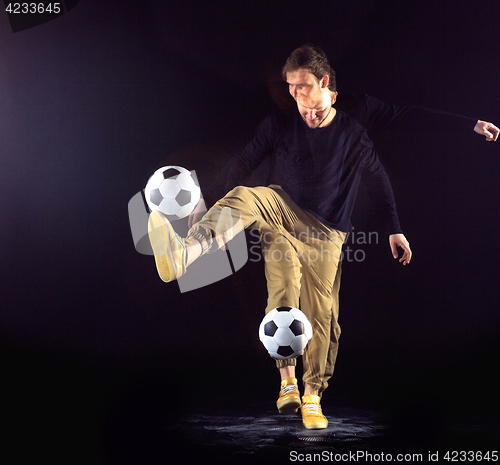 Image of A portrait of a fan with ball on gray studio background. Freestile