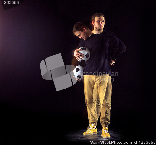 Image of A portrait of a fan with ball on gray studio background. Freestile