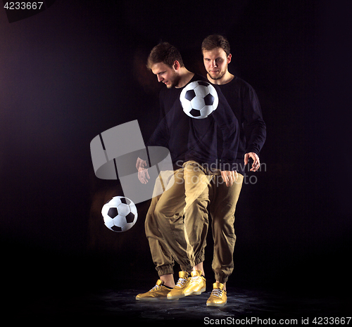 Image of A portrait of a fan with ball on gray studio background. Freestile