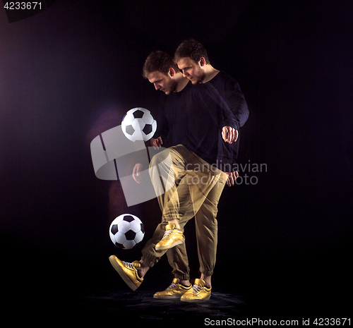 Image of A portrait of a fan with ball on gray studio background. Freestile