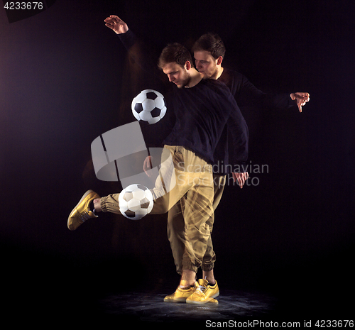 Image of A portrait of a fan with ball on gray studio background. Freestile