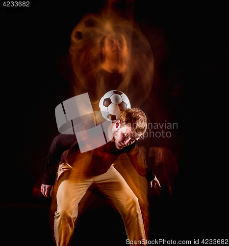 Image of A portrait of a fan with ball on gray studio background. Freestile