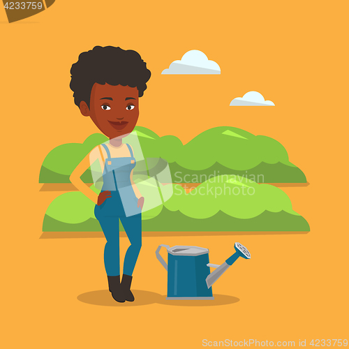 Image of Farmer with watering can at field.