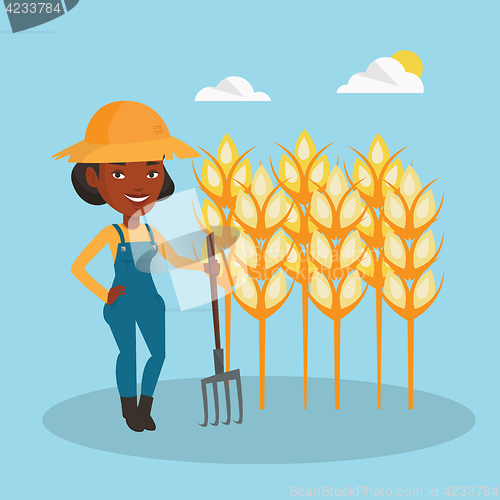 Image of Farmer with pitchfork at wheat field.