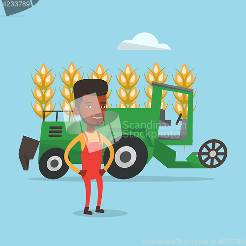 Image of Farmer standing with combine on background.