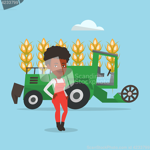 Image of Farmer standing with combine on background.