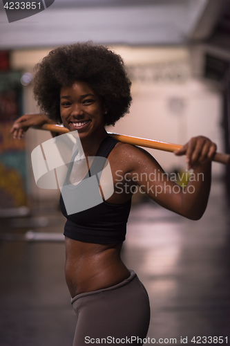 Image of black woman lifting empty bar