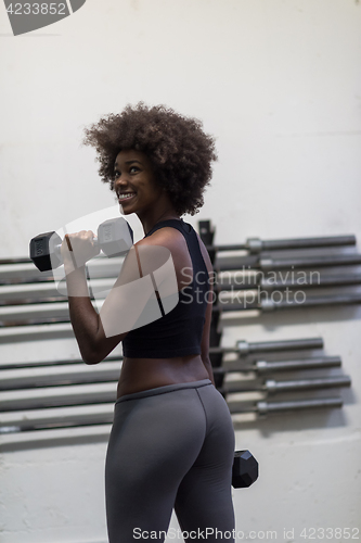 Image of black woman doing bicep curls