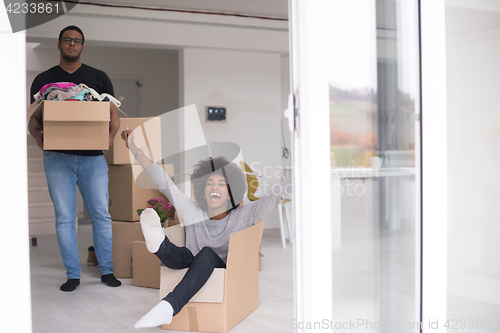 Image of African American couple  playing with packing material