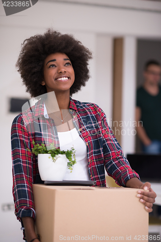 Image of Black girl moving in the new apartment