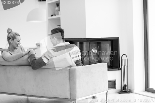 Image of Young couple  in front of fireplace