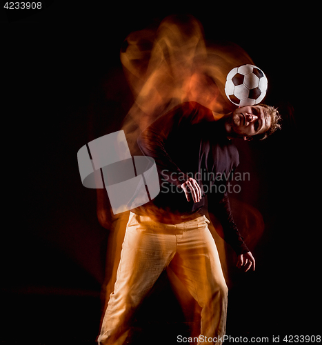 Image of A portrait of a fan with ball on gray studio background. Freestile