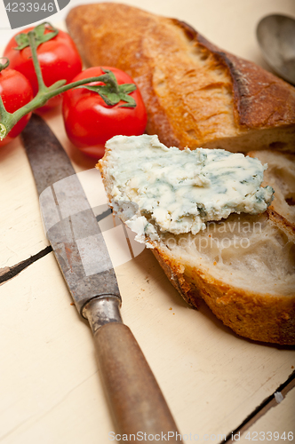 Image of fresh blue cheese spread ove french baguette