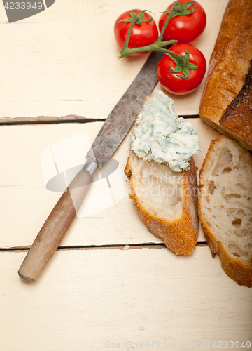 Image of fresh blue cheese spread ove french baguette