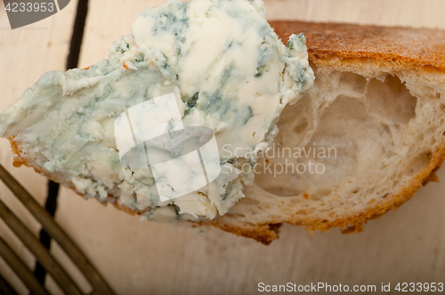 Image of fresh blue cheese spread ove french baguette