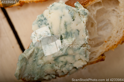 Image of fresh blue cheese spread ove french baguette