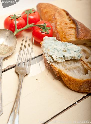 Image of fresh blue cheese spread ove french baguette