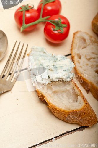 Image of fresh blue cheese spread ove french baguette