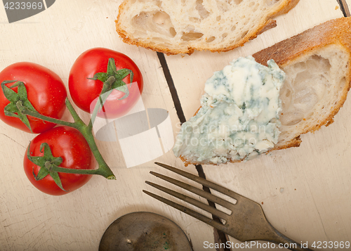 Image of fresh blue cheese spread ove french baguette