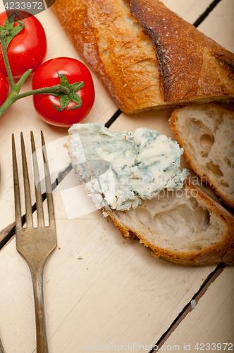 Image of fresh blue cheese spread ove french baguette