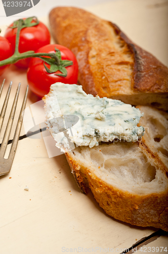 Image of fresh blue cheese spread ove french baguette