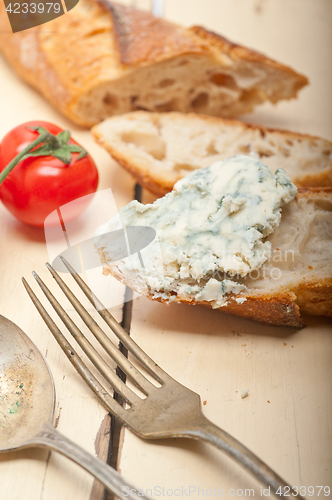 Image of fresh blue cheese spread ove french baguette