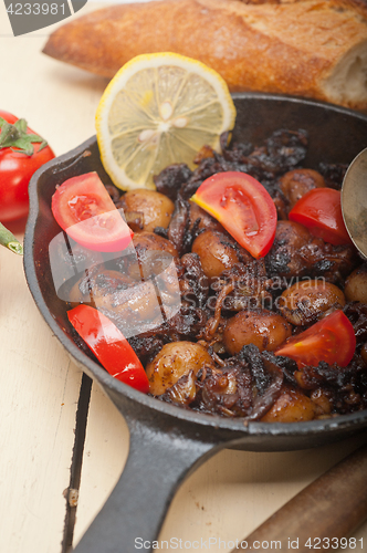 Image of Baby cuttle fish roasted on iron skillet