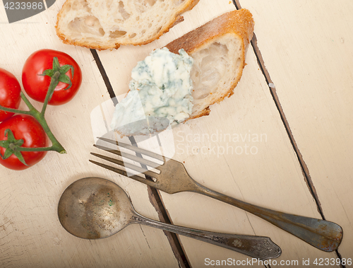 Image of fresh blue cheese spread ove french baguette