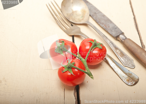 Image of ripe cherry tomatoes over white wood