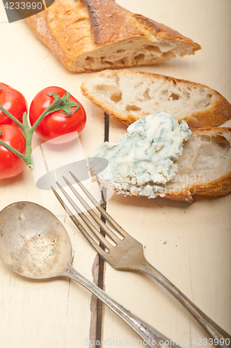 Image of fresh blue cheese spread ove french baguette