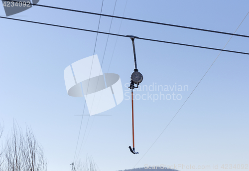 Image of Snowboarder using a surface lift on the slope.