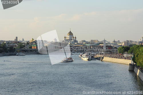 Image of Moskva river with river buses from Novoandreevskiy Bridge. Krymsky bridge and Cathedral of Christ the Savior on the horizon in Moscow, Russia