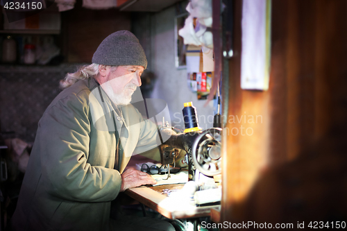 Image of Man sewing at home