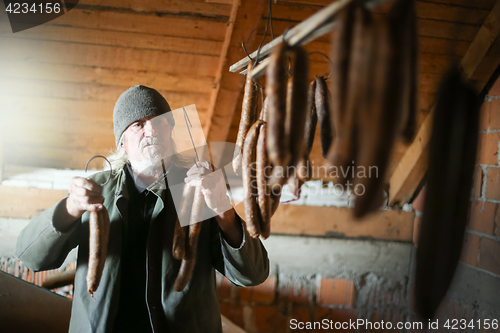 Image of Man drying sausages