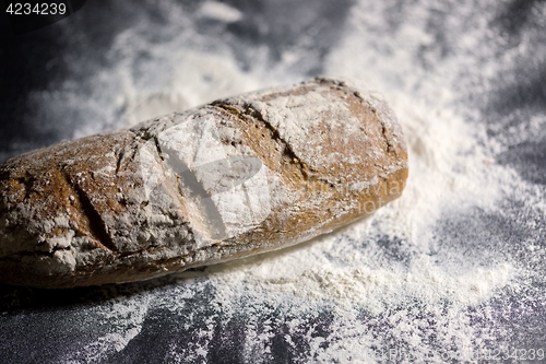 Image of Fully baked bread on flour