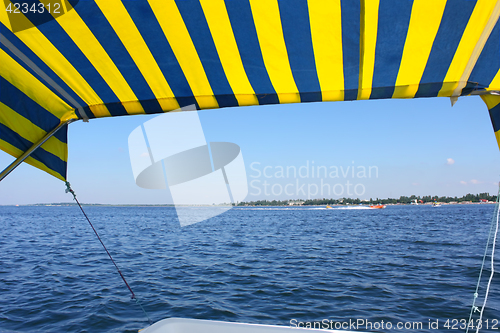 Image of Blue and yellow tent above water surface